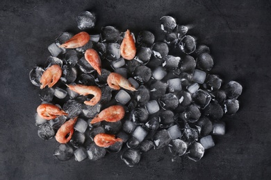 Photo of Flat lay composition with shrimps and ice cubes on dark background