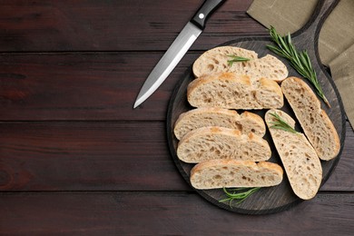 Photo of Delicious ciabatta with rosemary on wooden table, flat lay. Space for text