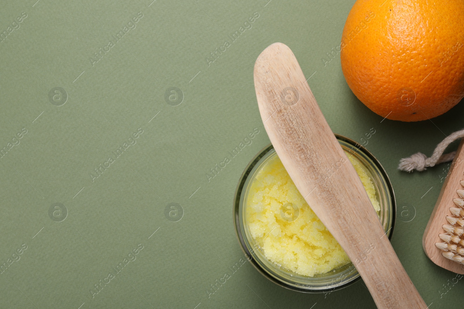 Photo of Flat lay composition with natural body scrub on olive background, space for text. Anti cellulite treatment