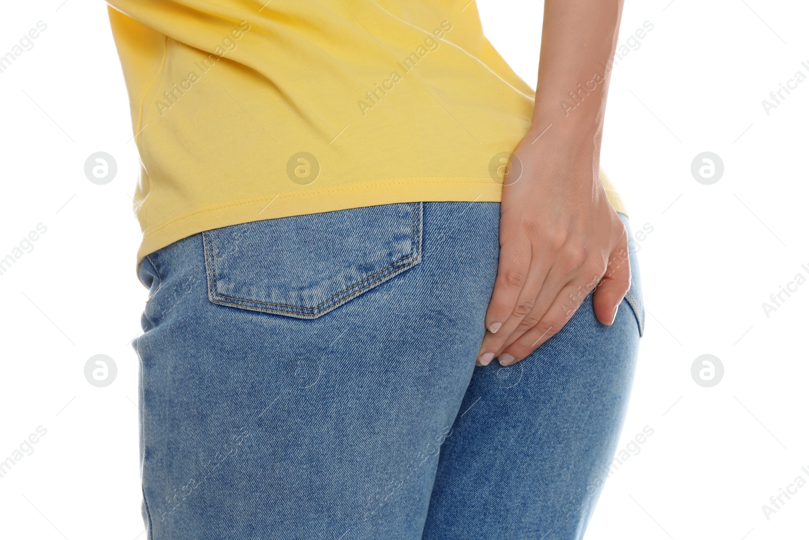 Photo of Woman suffering from hemorrhoid on white background, closeup
