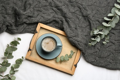 Photo of Flat lay composition with coffee and warm plaid on white bedsheet
