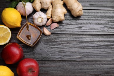 Different natural cold remedies on wooden table, flat lay with space for text. Cough treatment