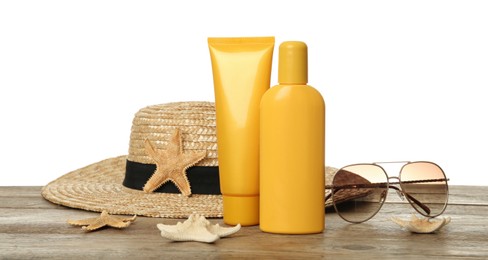 Sun protection products and beach accessories on wooden table