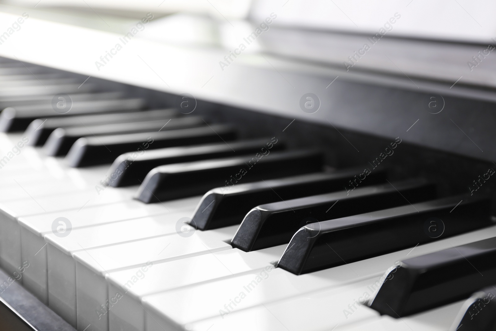 Photo of Modern piano with black and white keys, closeup