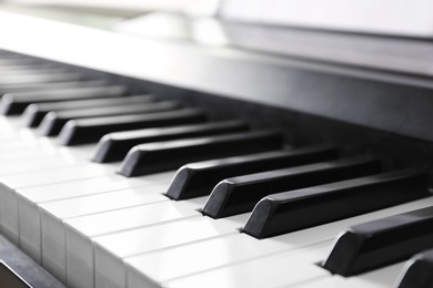 Photo of Modern piano with black and white keys, closeup