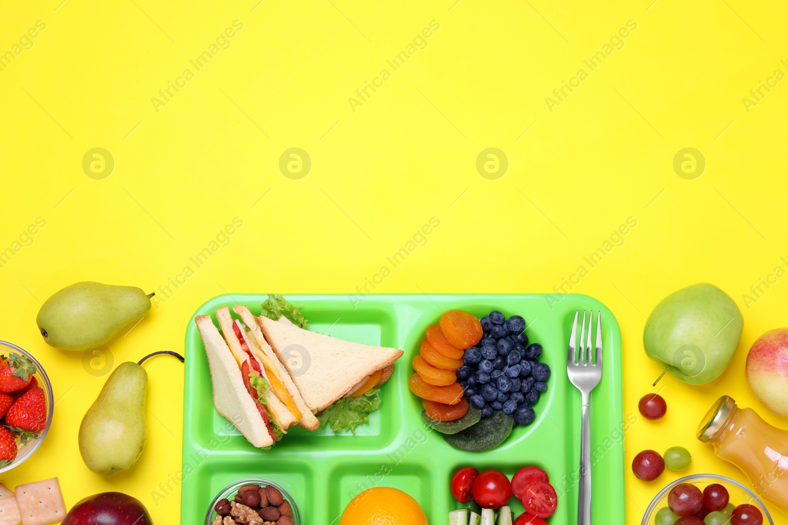 Photo of Flat lay composition with serving tray and tasty healthy food on yellow background. Space for text