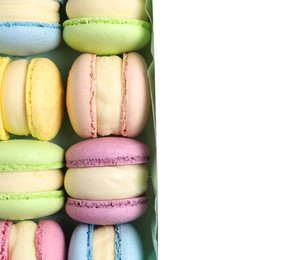 Photo of Many delicious colorful macarons in box on white background, top view