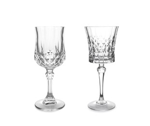 Two beautiful empty glasses on white background