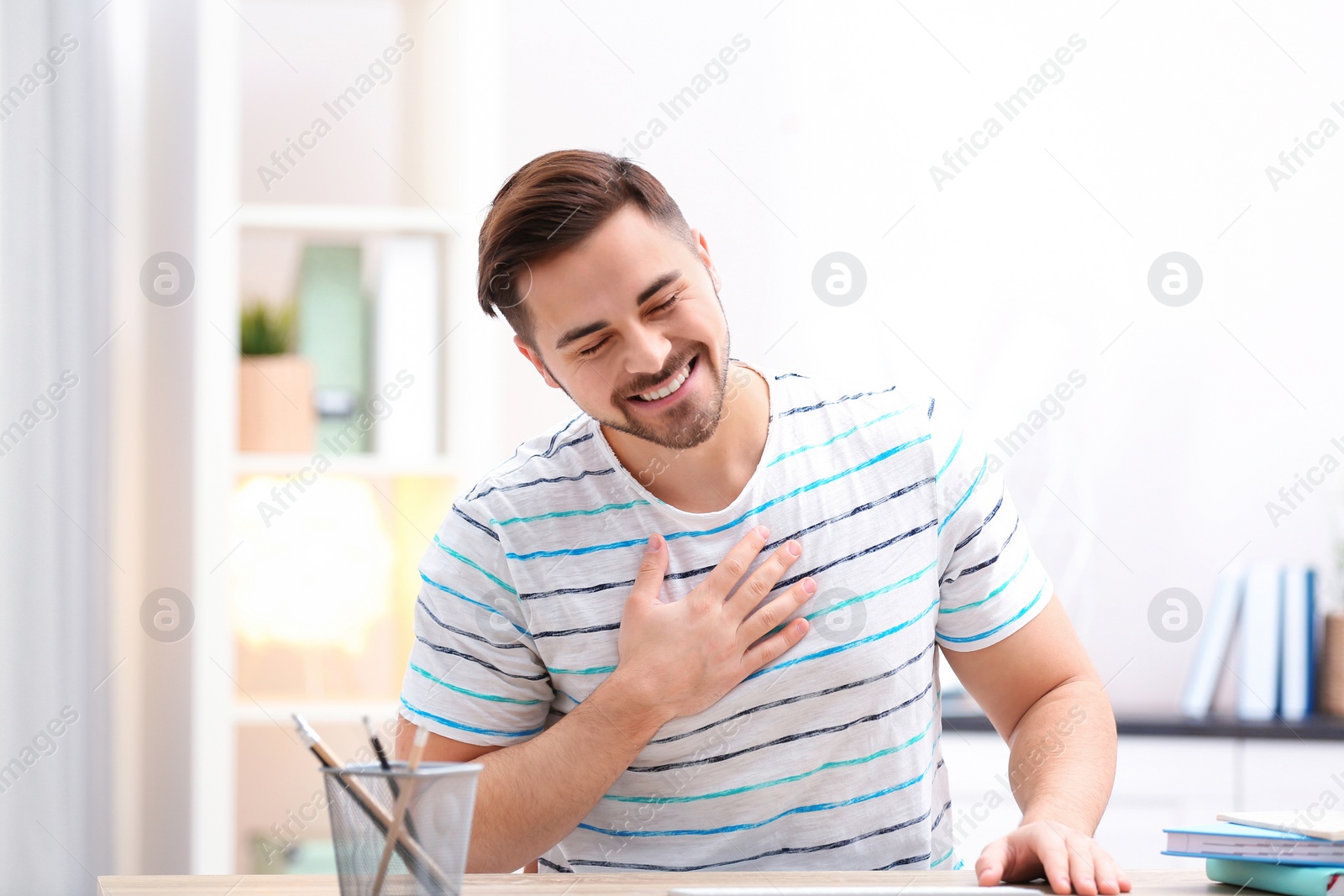 Photo of Handsome man using video chat for conversation indoors