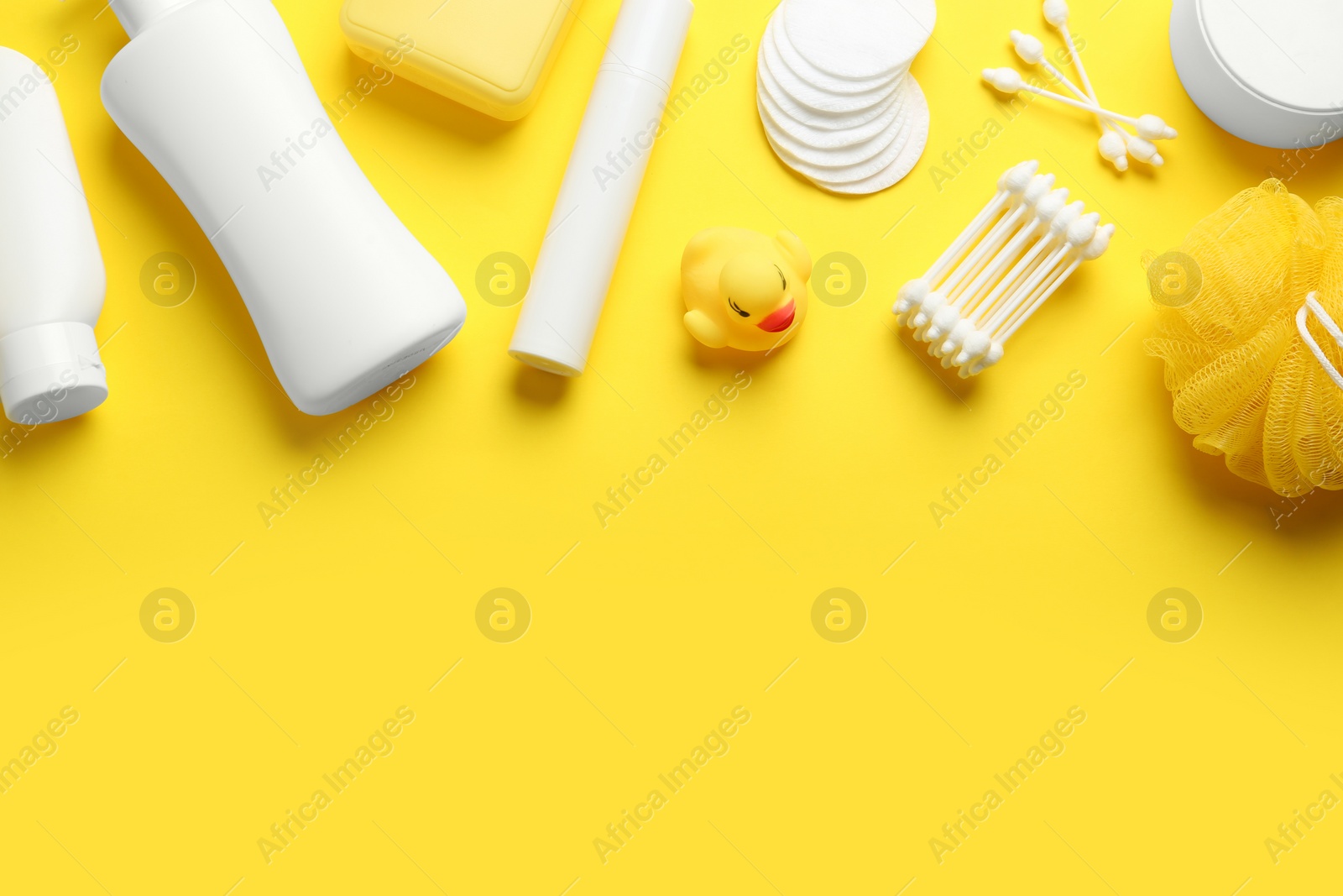 Photo of Flat lay composition with baby cosmetic products on yellow background. Space for text