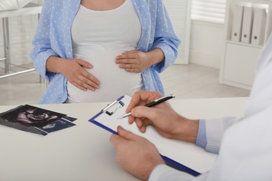 Photo of Pregnant woman having appointment at gynecologist office, closeup