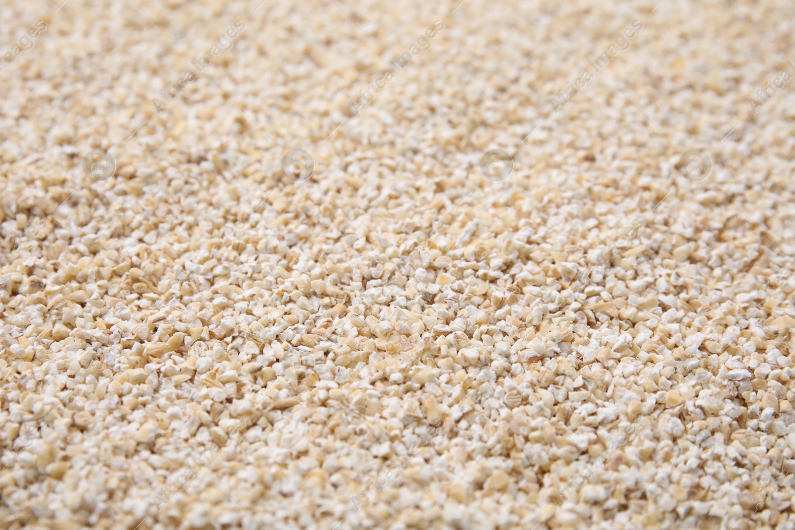 Photo of Raw barley groats as background, closeup view