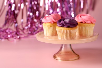 Photo of Delicious cupcakes with bright cream on pink background, space for text