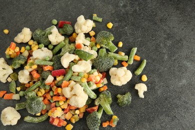 Mix of different frozen vegetables on gray table, above view