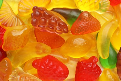 Photo of Tasty jelly candies in shape of different fruits, closeup