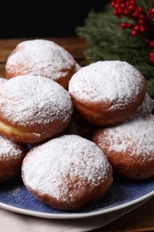 Delicious sweet buns with powdered sugar on table, closeup