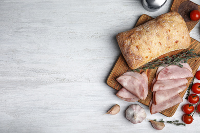 Photo of Tasty ham served on white wooden table, flat lay. Space for text