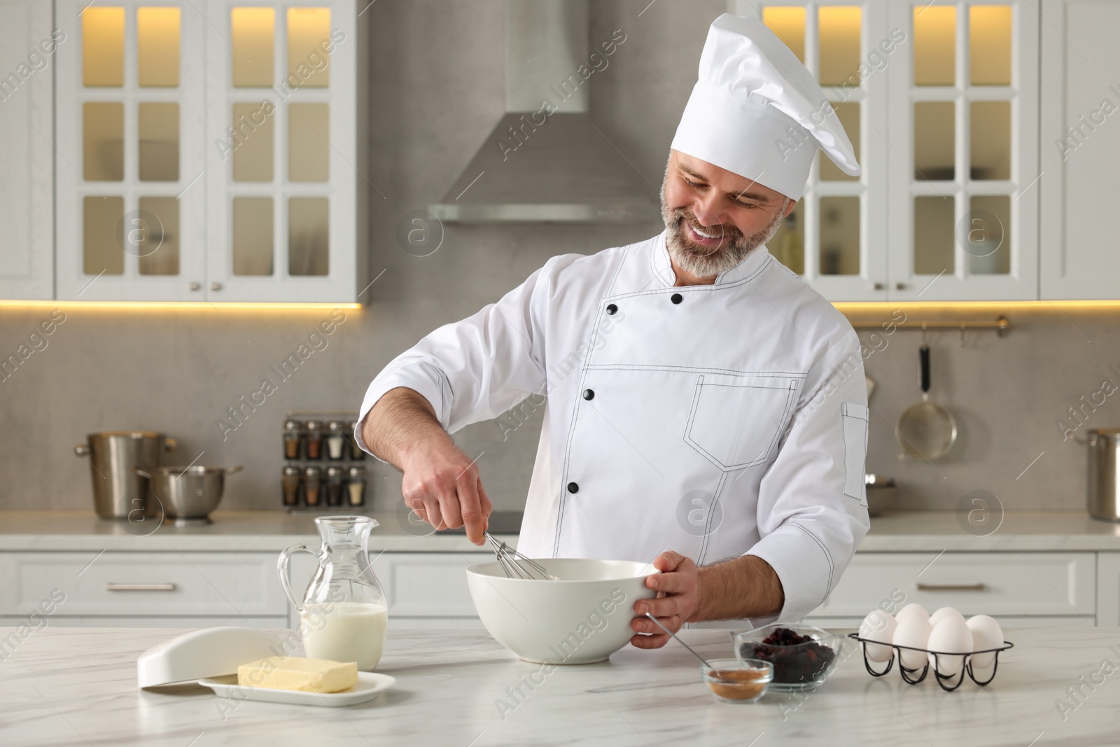 Photo of Professional chef making dough at white marble table in kitchen