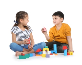 Cute children playing with colorful blocks on white background