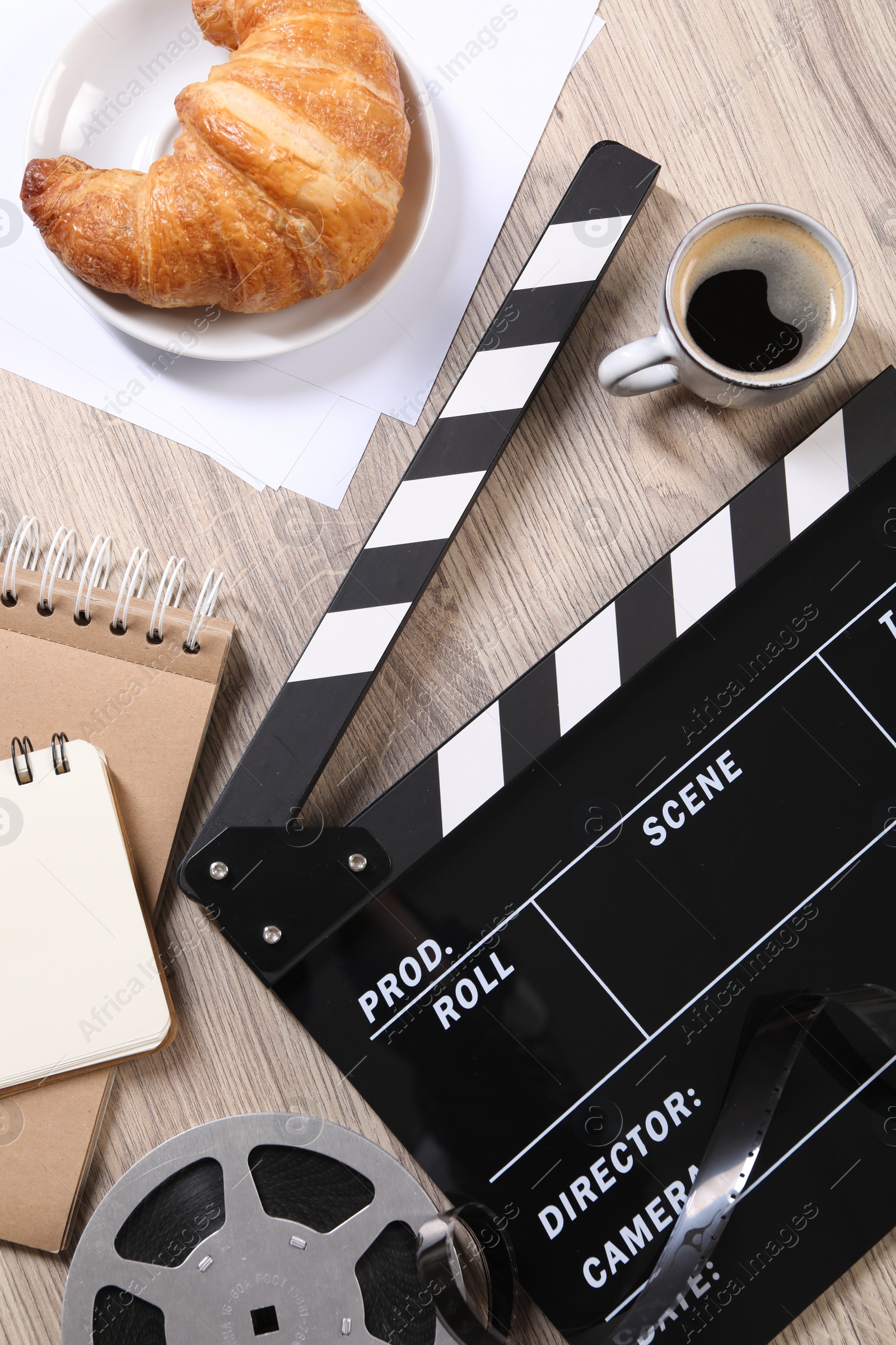 Photo of Flat lay composition with movie clapper on wooden table