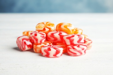 Photo of Pile of delicious colorful candies on wooden table