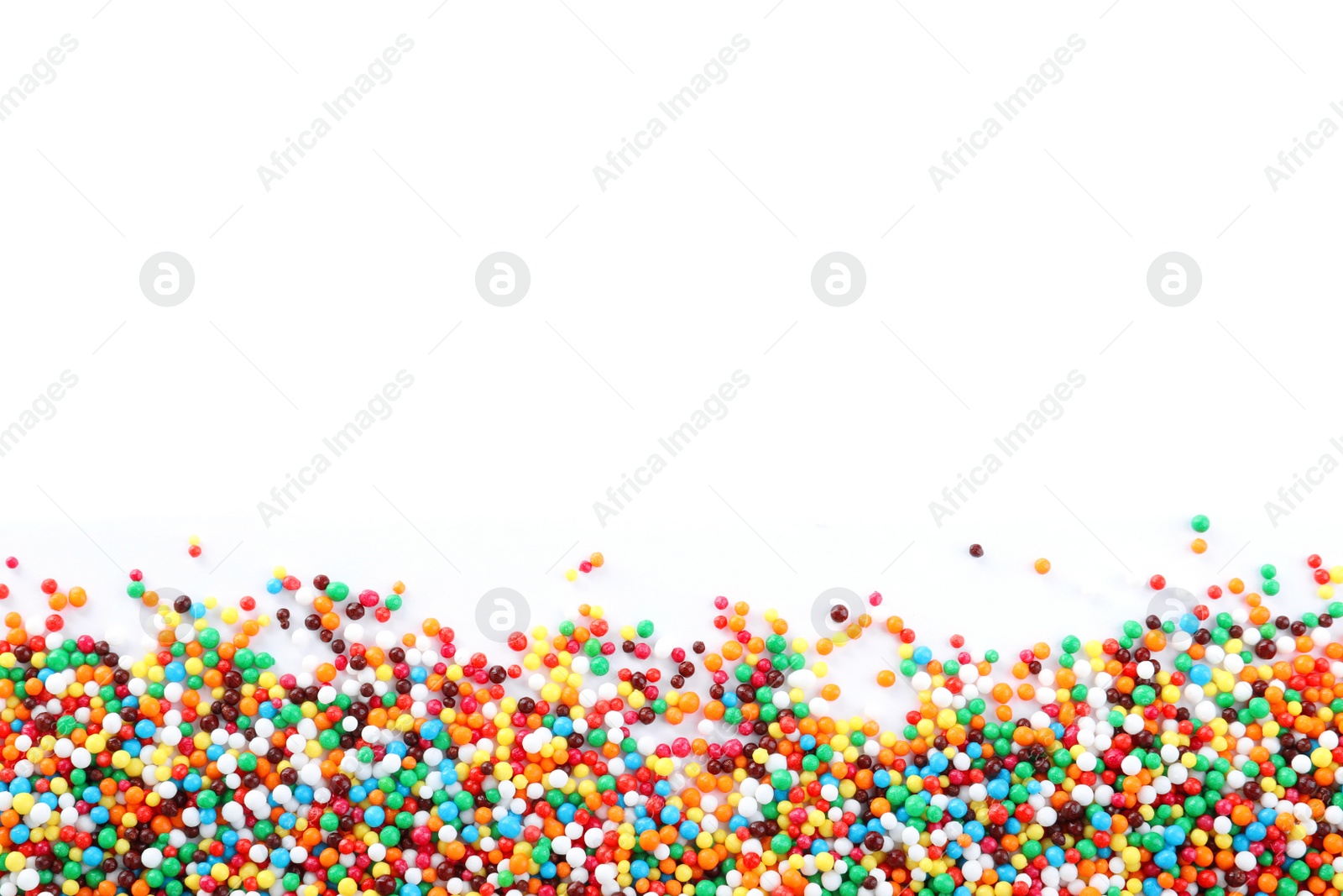 Photo of Colorful sprinkles on white background, top view. Confectionery decor