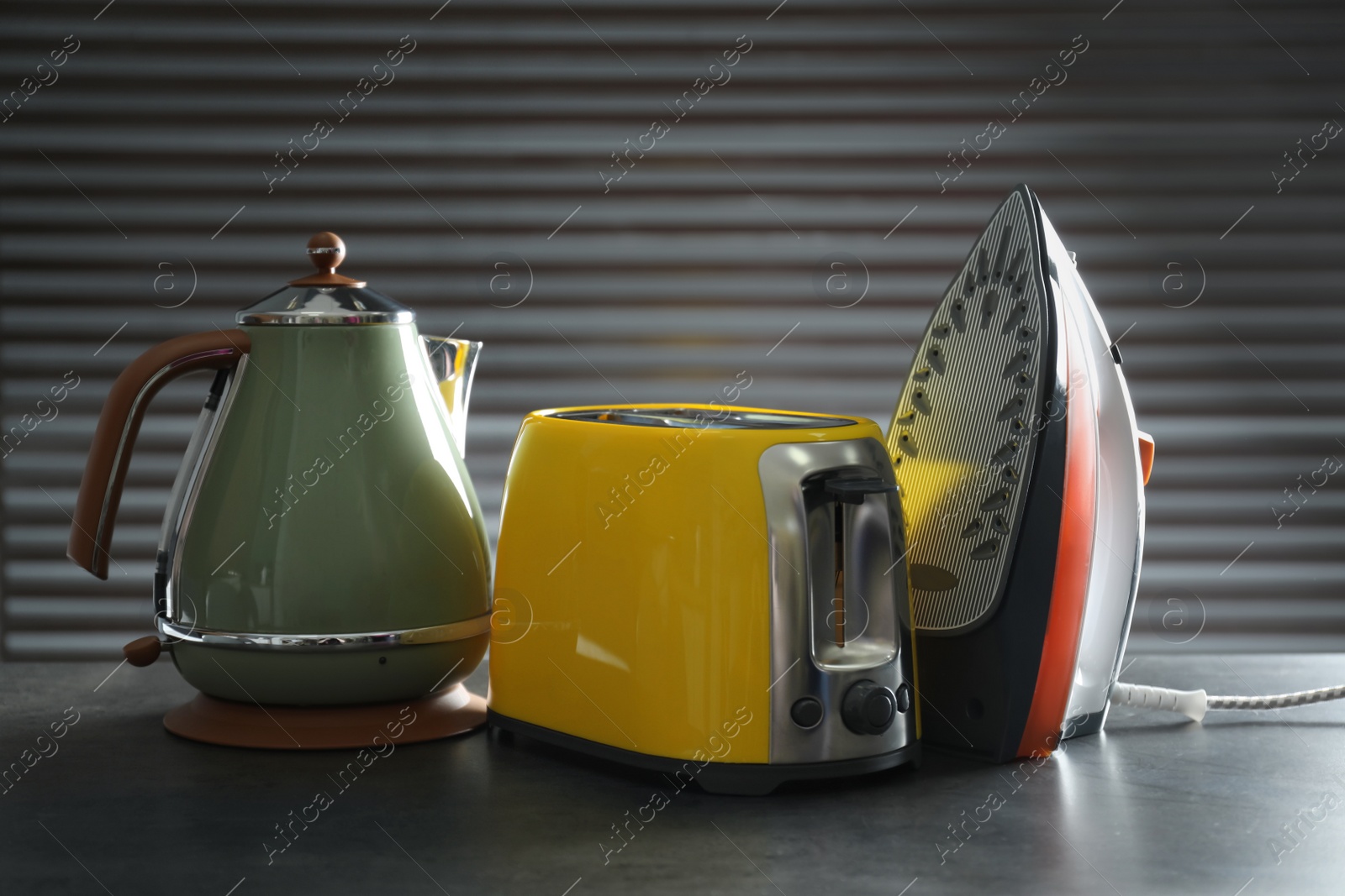 Photo of Set of modern home appliances on grey table