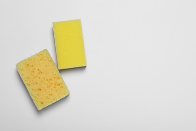 Photo of Sponges on white background, flat lay. Space for text