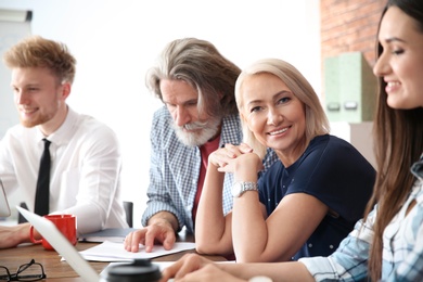 Photo of Business people discussing work matters in office. Professional communication