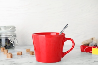 Photo of Cup of delicious hot tea on table