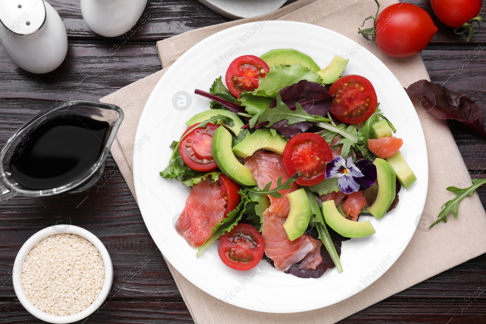 Photo of Tasty soy sauce and salad on wooden table, flat lay