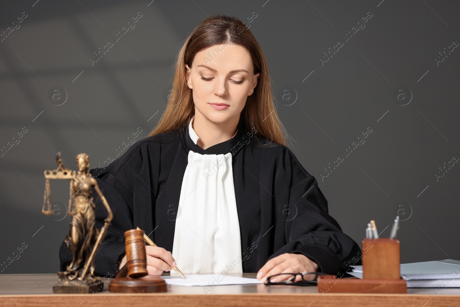 Photo of Judge working with document at table indoors