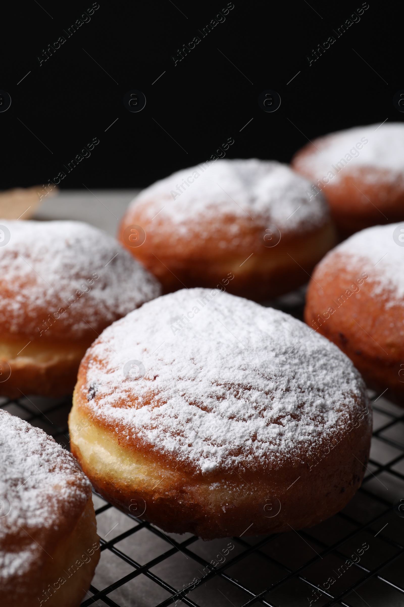 Photo of Delicious sweet buns on table against black background, closeup