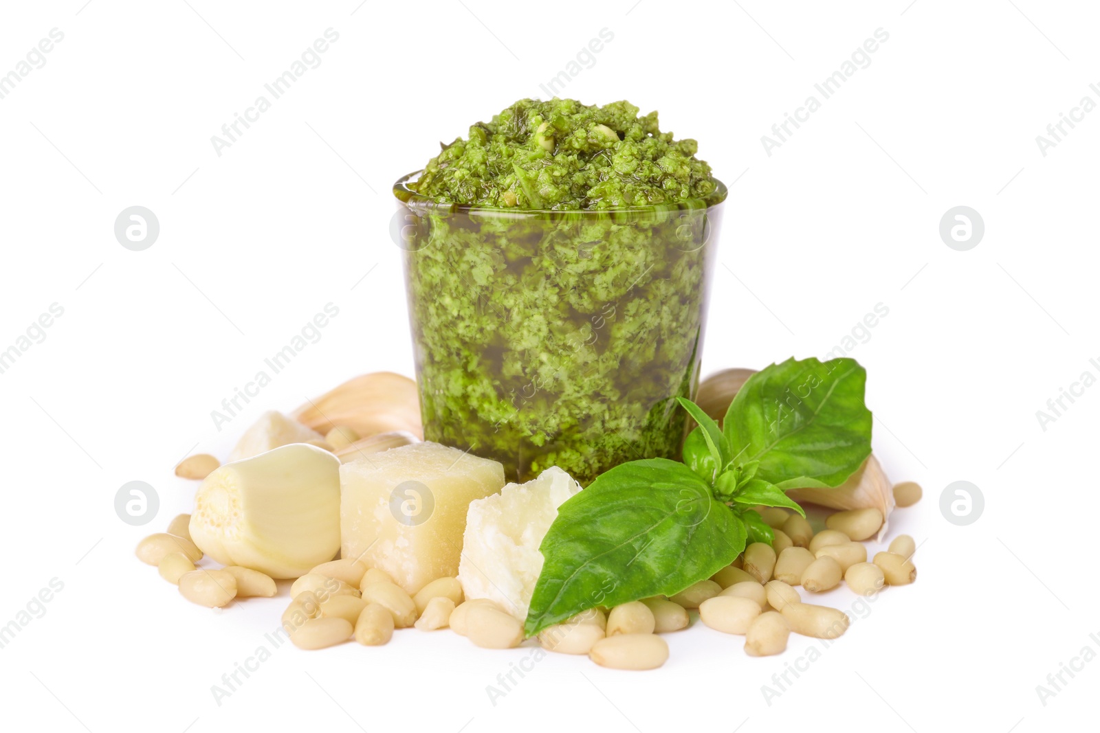 Photo of Composition with glass of tasty pesto sauce isolated on white