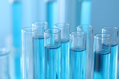 Test tubes with light blue liquid in laboratory, closeup