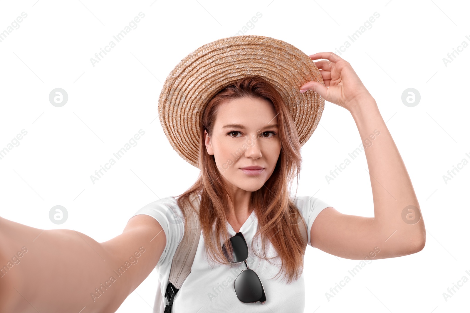 Photo of Beautiful woman in straw hat taking selfie on white background