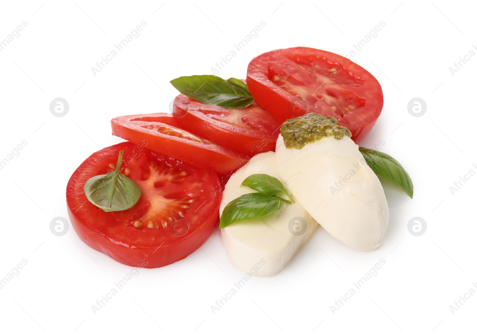 Photo of Delicious Caprese salad with tomatoes, mozzarella cheese, basil leaves and pesto sauce isolated on white