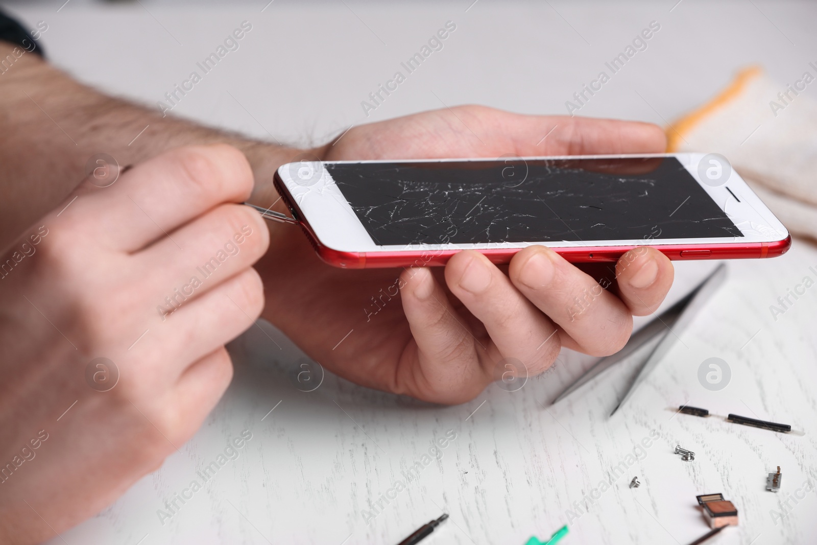 Photo of Technician fixing mobile phone at table, closeup. Device repair service