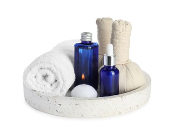 Spa composition. Bottles of cosmetic products, towel, herbal bags and burning candle isolated on white