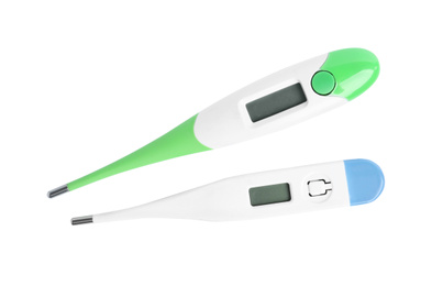 Photo of Modern digital thermometers on white background, top view