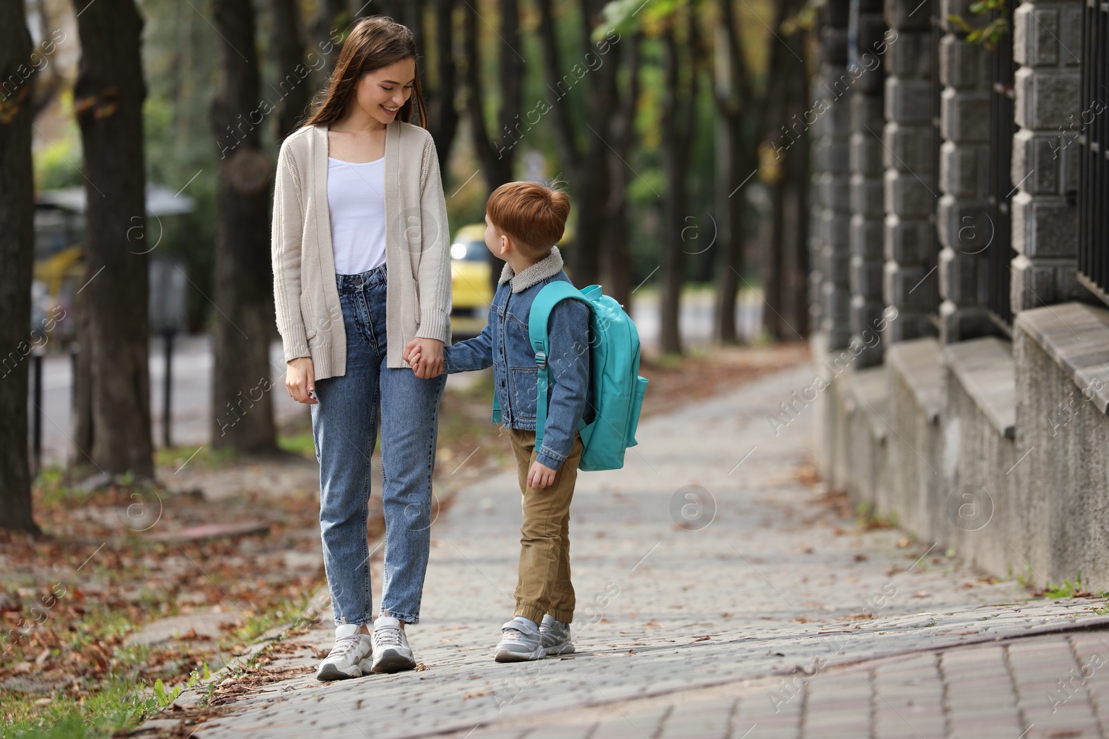 Photo of Young mom taking her son to school