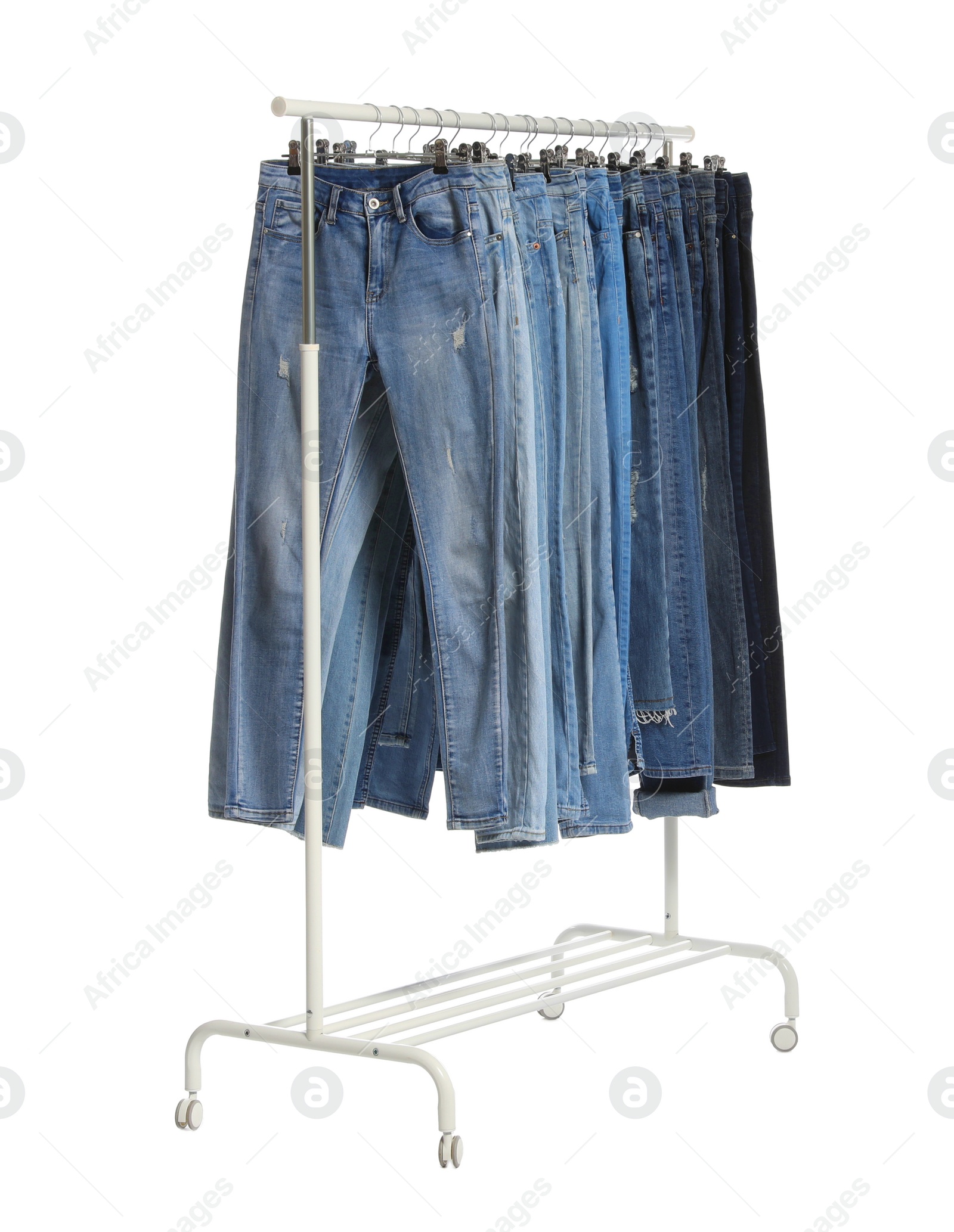 Photo of Rack with different jeans isolated on white