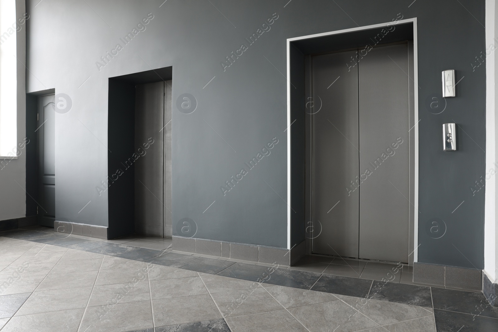 Photo of Closed stylish elevator doors in clean hall