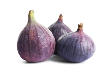 Whole ripe purple figs on white background