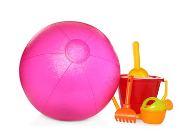 Photo of Inflatable pink beach ball and child plastic toys on white background