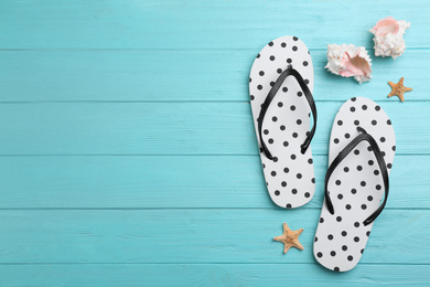 Photo of Flat lay composition with flip flops on light blue wooden background. Space for text