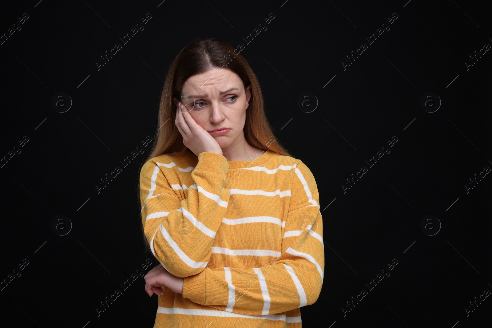 Photo of Portrait of sad woman on black background