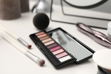 Photo of Mirror and cosmetic products on dressing table, closeup