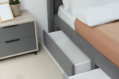 Photo of Storage drawers for bedding under modern bed in room