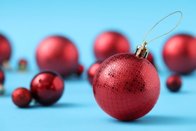 Photo of Beautiful Christmas balls on light blue background